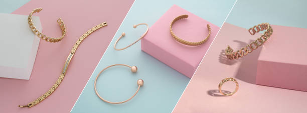 Golden accessories collection on pastel colors pink and blue background