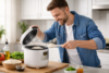 Man serving freshly cooked rice from a compact rice cooker in a home kitchen